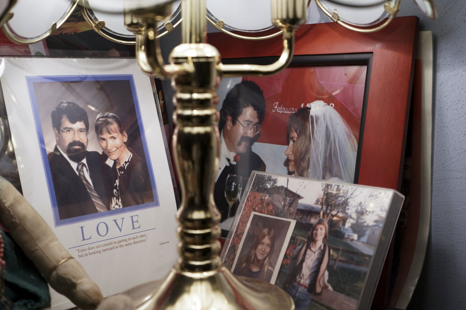 Framed photos of Robert Morrison and Pam Harbour are displayed on a table